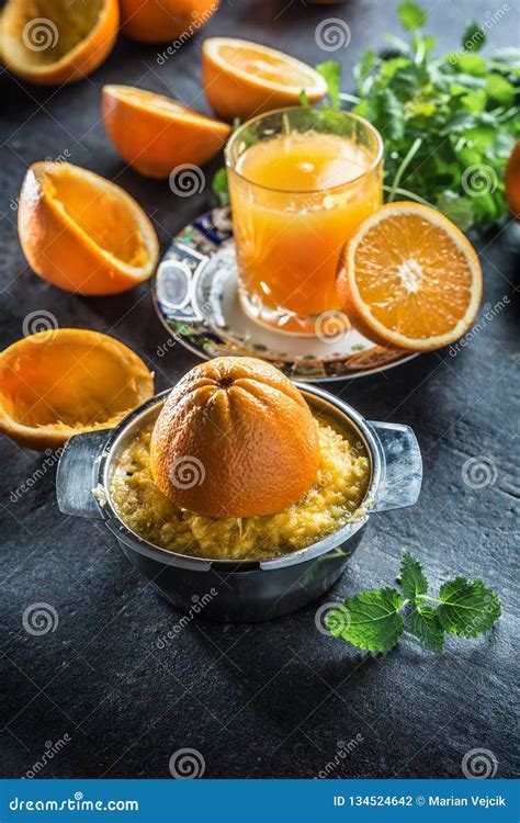 Fresh Oranges Juicer Juice Tropical Fruits And Herbs On Concrete Board
