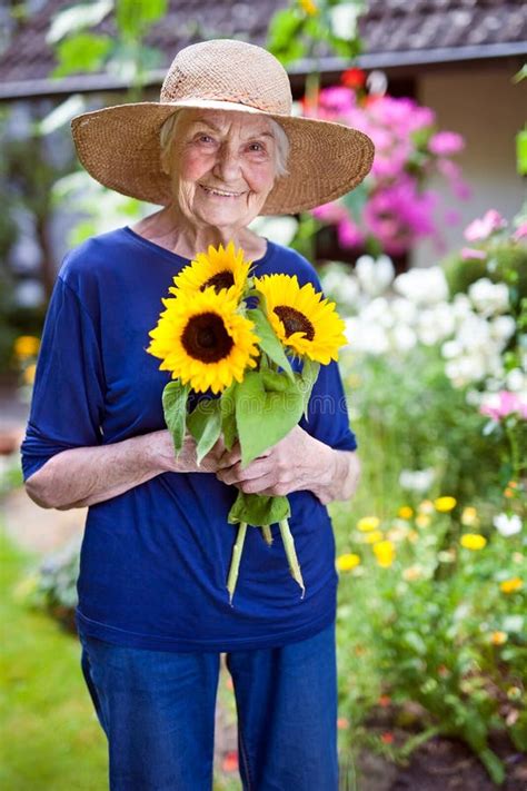 Happy Senior Woman Holding Pretty Sunflowers Stock Image Image Of