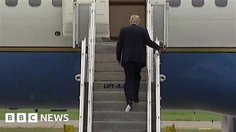 trump boards plane with paper stuck to his shoe