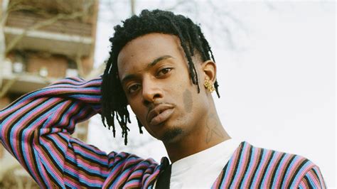 Twisted Hair Playboi Carti Is Wearing Pink Blue Black Lines Dress Standing In White Sky