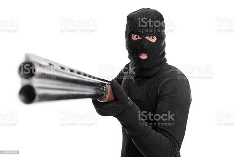 Angry Criminal Pointing A Shotgun At The Camera Stock Photo Download