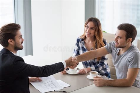 Happy Millennial Couple And Realtor Shake Hands Making Property Deal Stock Image Image Of