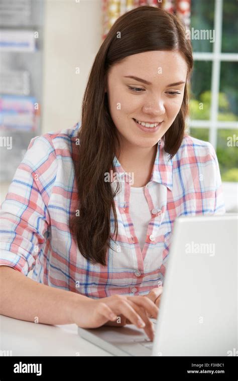 Teenage Girl Using Laptop At Home Stock Photo Alamy