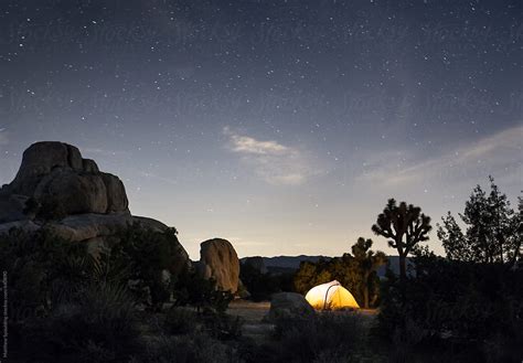 Camping Tent Illuminated At Night Under Bright Starry Sky By Stocksy