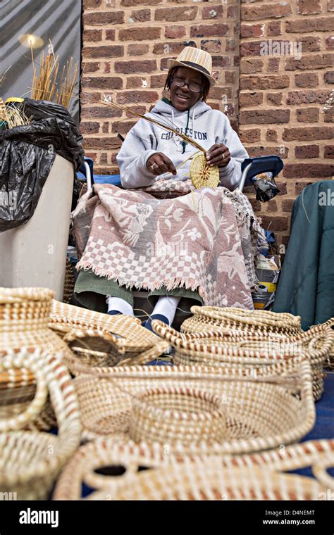 Gullah Woman Weaving Sweetgrass Baskets At The Historic Charleston City Market On Market Street