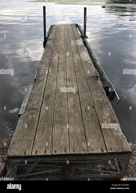 Old Boat Dock Leading Into A Lake Stock Photo Alamy