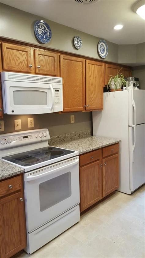 Popular white kitchen cabinets gleam with pizzazz, do you agree? Greenish Gray | Cream colored kitchen cabinets, Kitchen ...