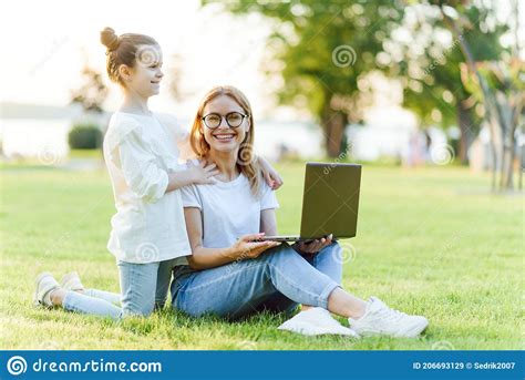 Mom And Daughter With Laptop Resting On Meadow Stock Image Image Of