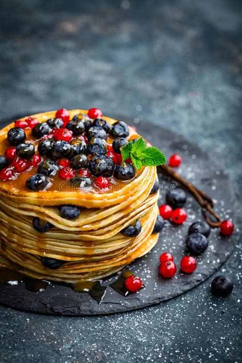 Pancakes With Fresh Berries And Maple Syrup On Dark Background Stock