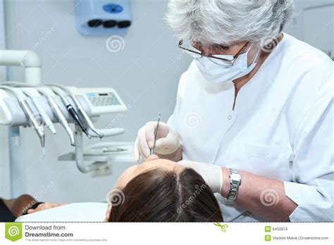 Helping you manage the high cost of dental work with dental financing offered by umc. Dentist At Work In Dental Room Stock Images - Image: 6432874