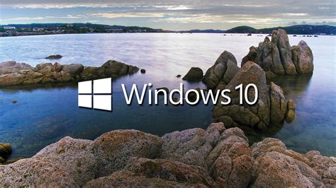 Windows 10 White Text Logo On The Rocky Lake Shore Wallpaper Computer