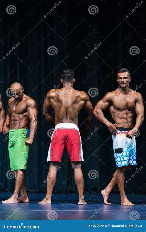 Mens Physique Posing During A Bodybuilding Competition Stock Photo
