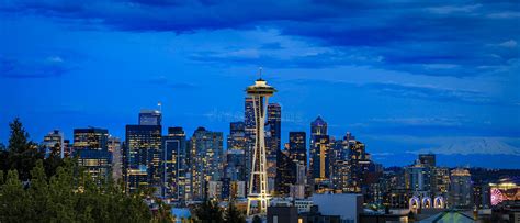 Sunset Skyline Panorama With The Space Needle And Mount Rainier In