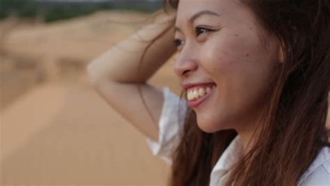 Asian Woman Smile Outdoor Desert Wind Blowing Hair Wear White Shirt Close Up Face Of Young