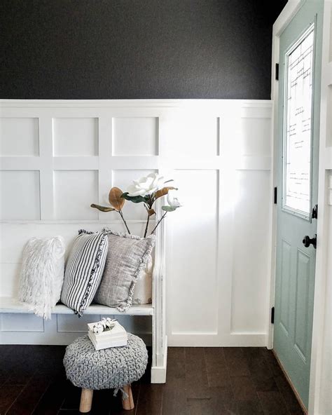 A White Bench Sitting In Front Of A Door With Pillows On It And A Plant