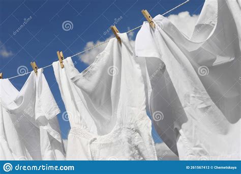 Clean Clothes Hanging On Washing Line Against Sky Closeup Drying
