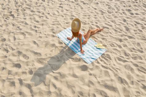 Woman Sunbathing On Beach Towel At Sandy Coast Stock Photo Download