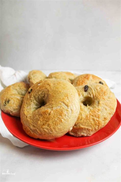 Cinnamon Raisin Bagel Recipe On A Red Plate With The Title In The Middle