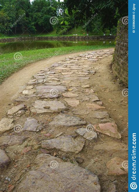 Ancient Stone Paved Roadway Next To A Pond In Rural Vietnam Stock Photo