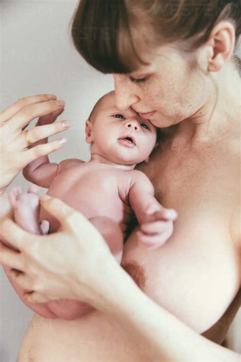 Nude Mother Holding Her Newborn Baby Stock Photo