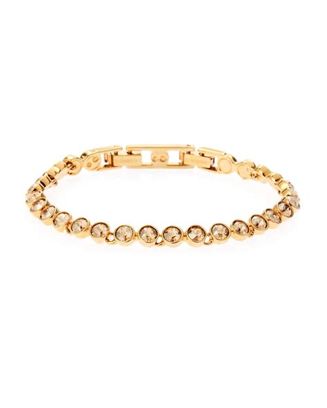 A charming gift giving idea. Swarovski Gold-Plated Tennis Bracelet in Metallic | Lyst
