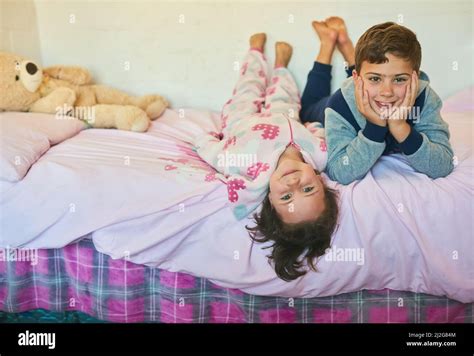 They Share A Special Sibling Bond Shot Of Two Young Siblings Lying Down Together On A Bed At