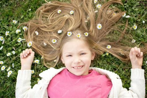 Premium Photo Beautiful Smiling Little Girl Lying On The Flower