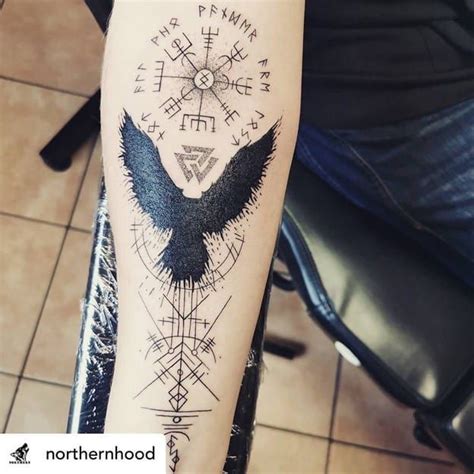 A Tattoo On The Arm Of A Person With An Eagle And Compass Design In