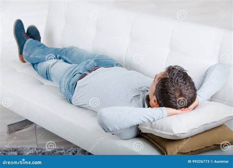 Middle Aged Man Having Restful Moment Relaxing In Sofa Stock Image