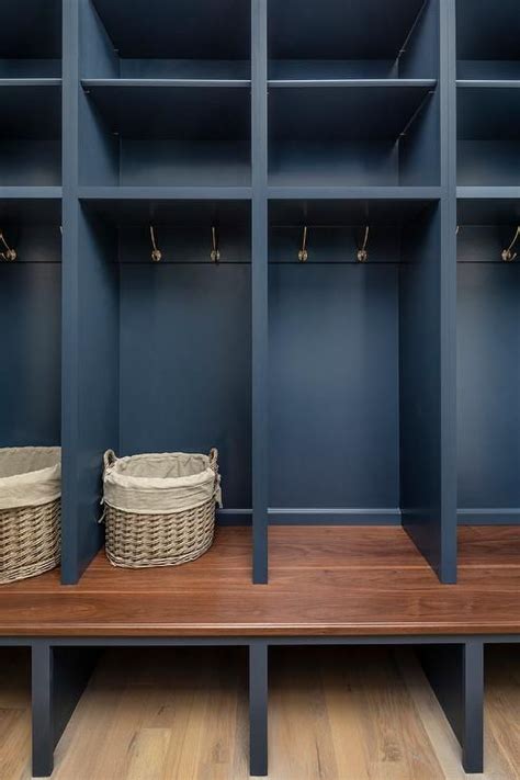 Dark Blue Open Mudroom Lockers Are Fitted With Brass Hooks Mounted Over