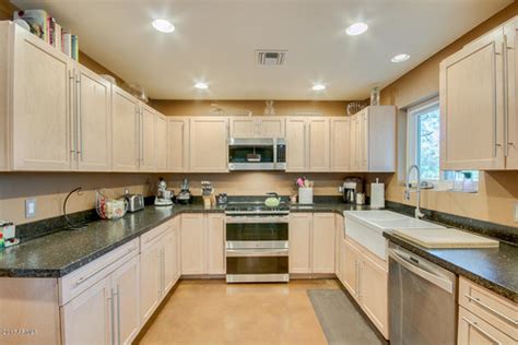 Kitchen cabinets that work and look smart. Light birch cabinets, dark countertop - paint color help ...