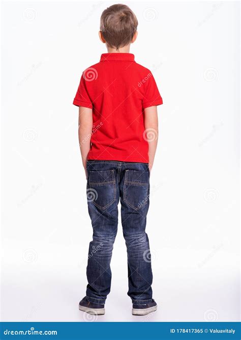 Full Length Portrait Of A Child Standing Back To The Camera Kid Stands