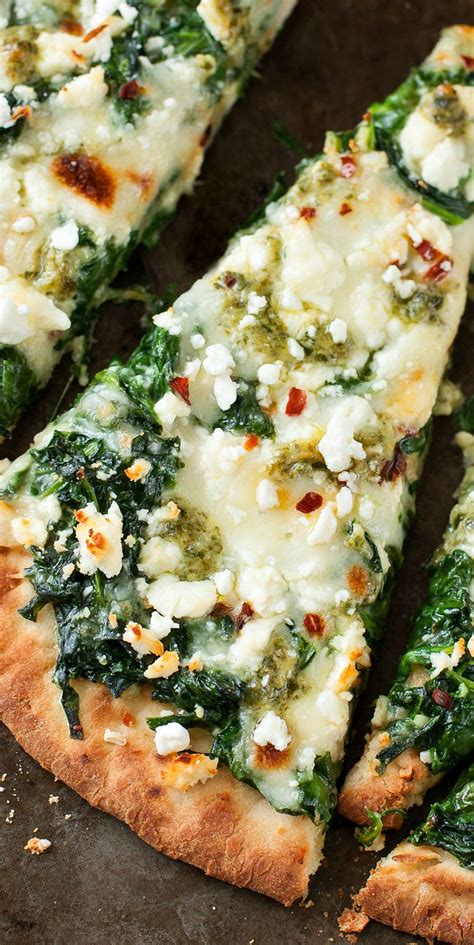 Place the flatbread on baking sheet; Three Cheese Pesto Spinach Flatbread Pizza