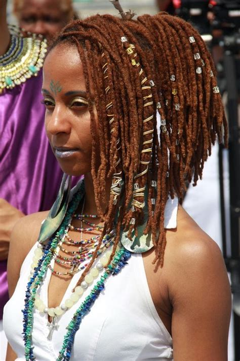 It's like a crisscross made of dreadlocks. Red, reddish brown, and brown colored locs, loc jewelry ...