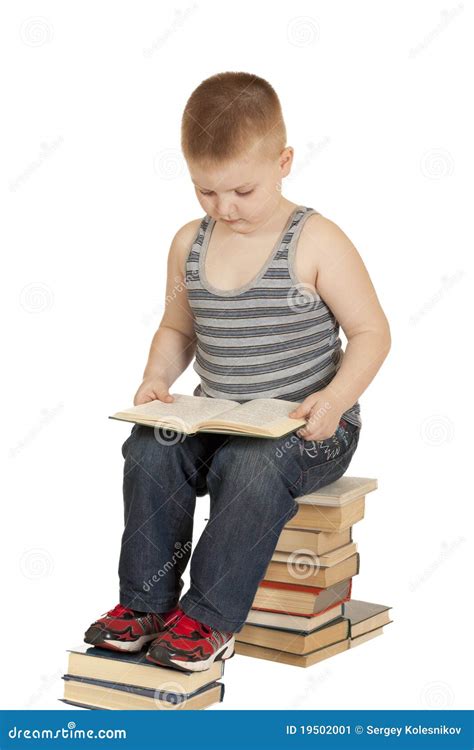 Little Boy Sitting On The Books And Reading A Book Stock Image Image