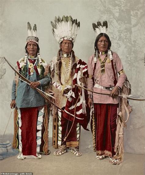 Three Native American Indians Standing Next To Each Other