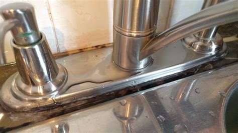When the handle is turned on the water puddles around the spout base. Kitchen faucet leaking from base. Replace or repair ...