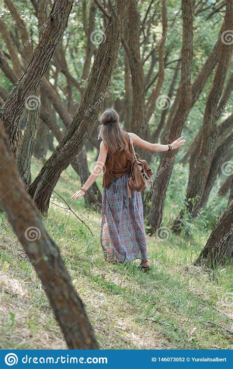 Rear Viewyoung Hippie Woman Standing Among The Trees In