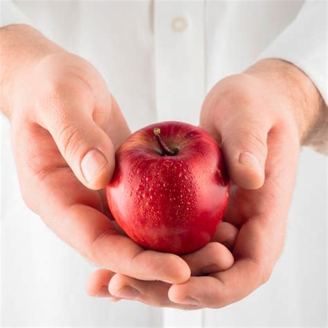 Free Photo Person Holding Red Apple In Hands