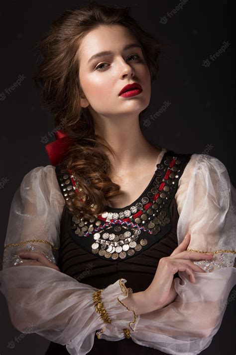 premium photo beautiful russian girl in national dress with a braid hairstyle and red lips