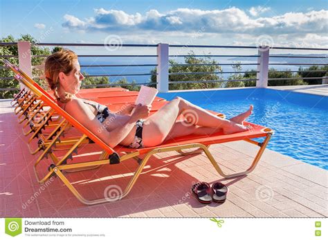 Caucasian Woman Sunbathing And Reading Book Stock Image Image Of