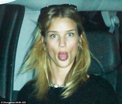 Rosie Huntington Whiteley Pokes Out Her Tongue As She Arrives Back In