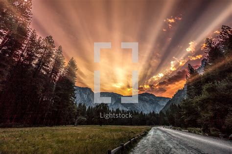 California has some of the toughest rules for security licensing & registration and this article explains california guard card licensing. Rays of sunlight behind mountains — Photo — Lightstock