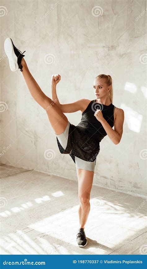 Focused Pretty Blond Posing In Battle Stance In Studio Stock Image