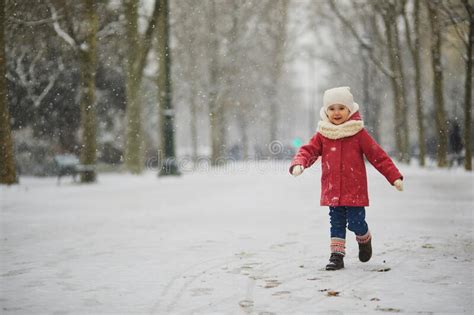 Adorable Toddler Girl On A Day With Heavy Snowfall Stock Photo Image