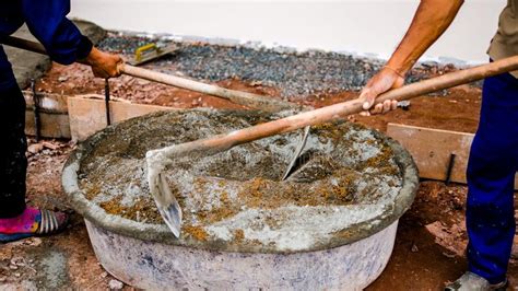 Construction Workers Are Mixing Concrete Cement And Sand Stock Photo