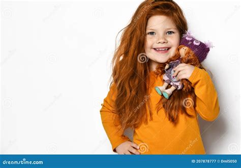 Frolic Smiling Five Year Old Red Haired Kid Girl In Orange Sweatshirt