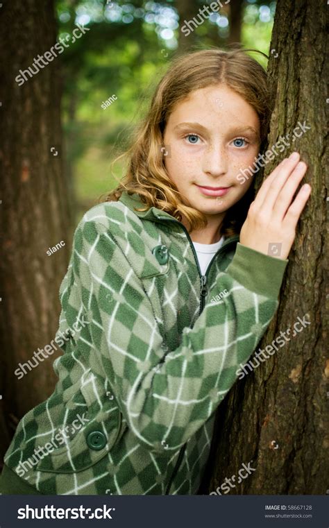 Tween Girl Leaning Against Tree Outdoors Stock Photo 58667128