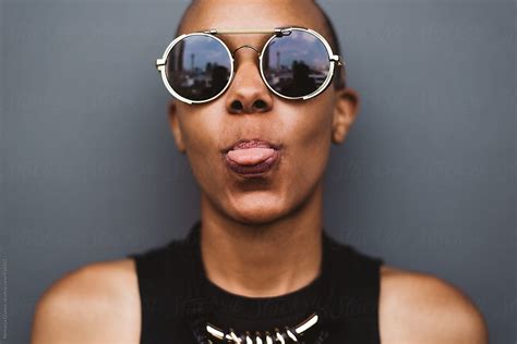 Silly African American Woman Sticking Tongue Out By Stocksy