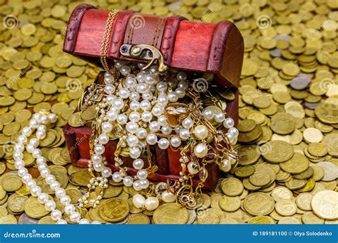 Vintage Treasure Chest Full Of Gold Coins And Jewelry On A Background